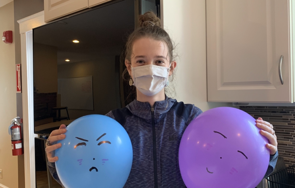 Middle School student holding two balloons