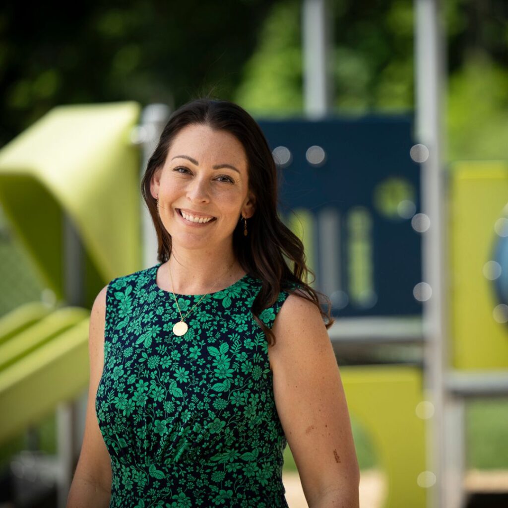 Brooke Hopkins, Head of School at Riverbend in front of playground