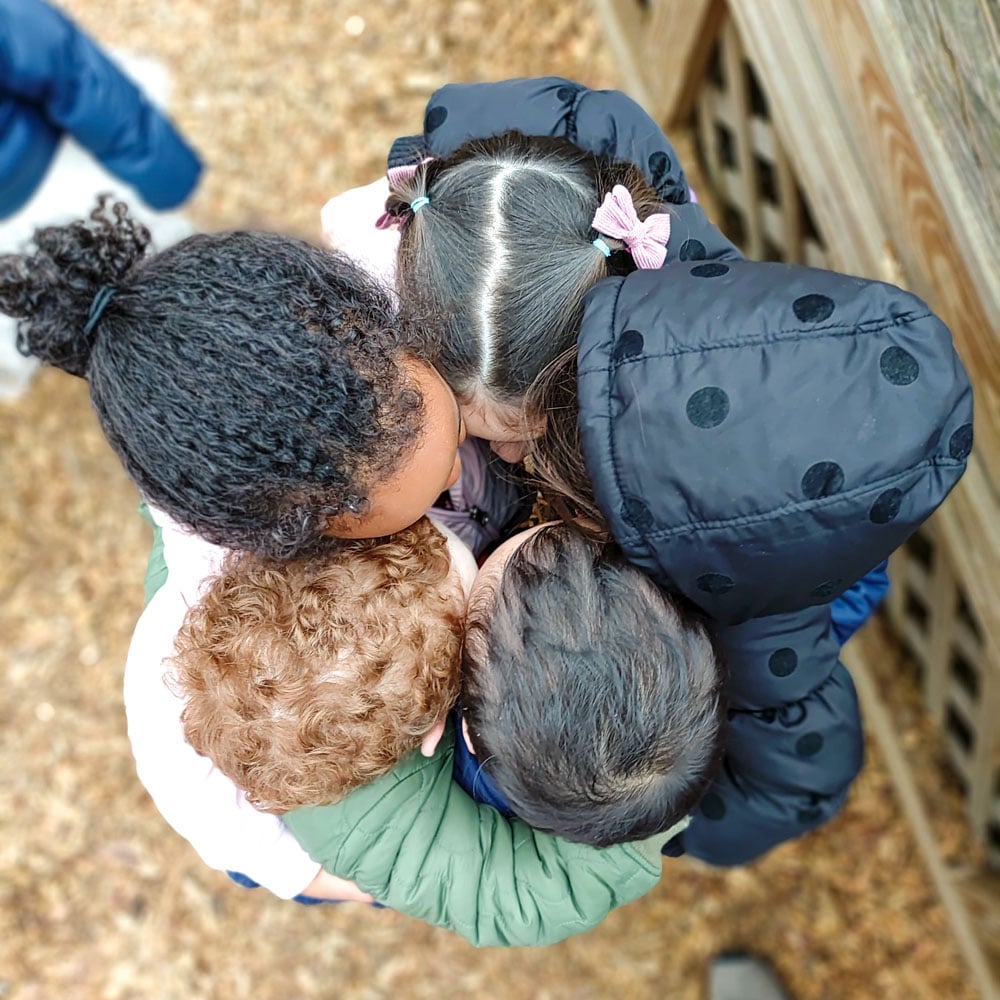 Children hugging at Riverbend