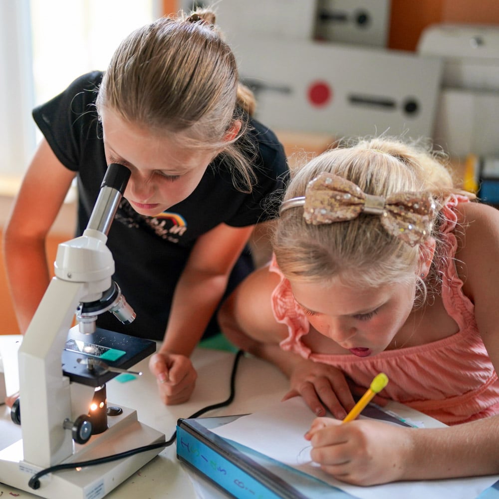 Riverbend students with microscope