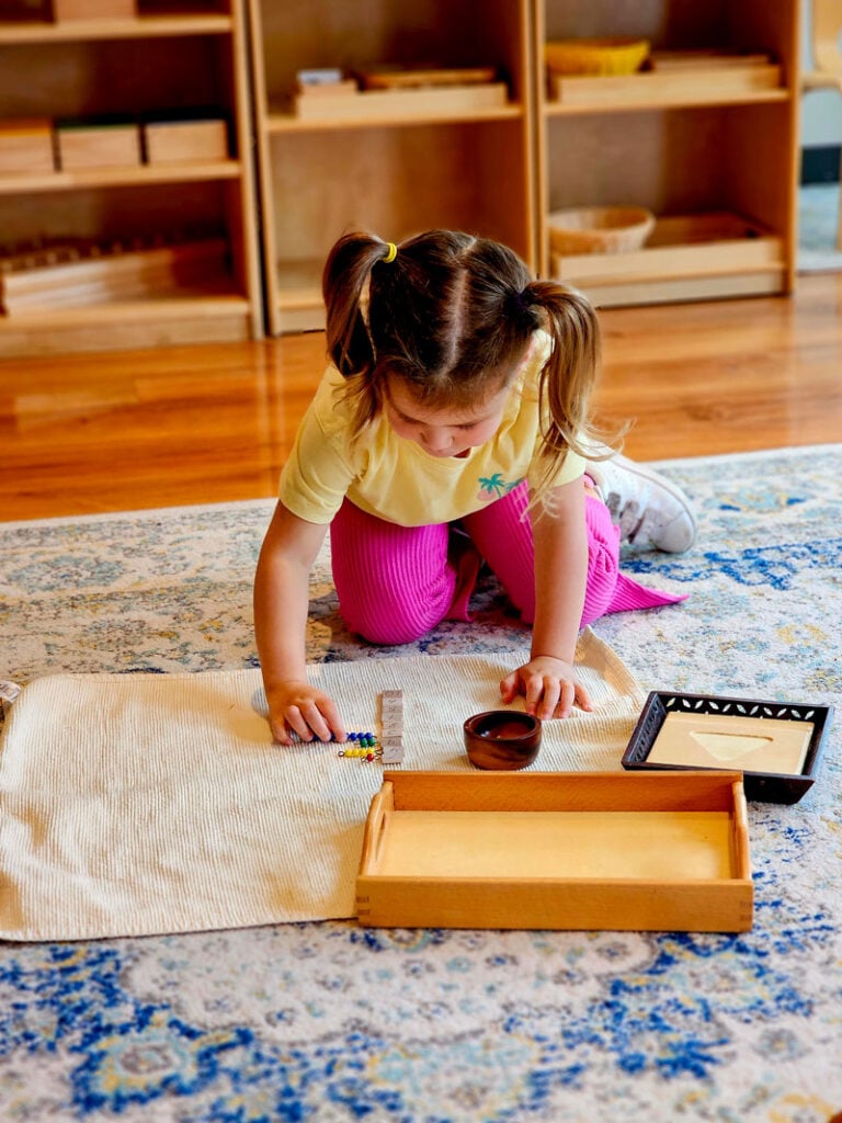 Montessori student working on a mat